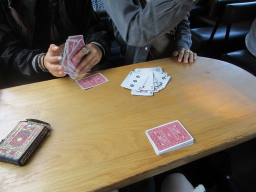 Playing Dou Di Zhu around a table with friends